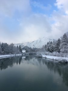 A lake and mountain covered in snow